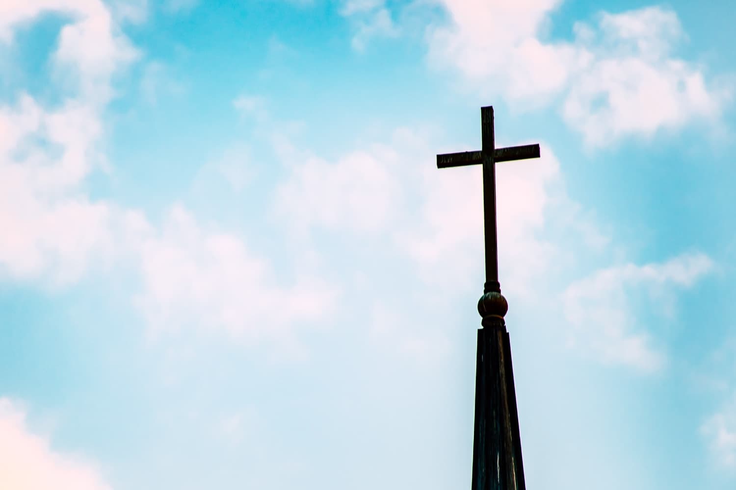 A cross silhouetted against the sky