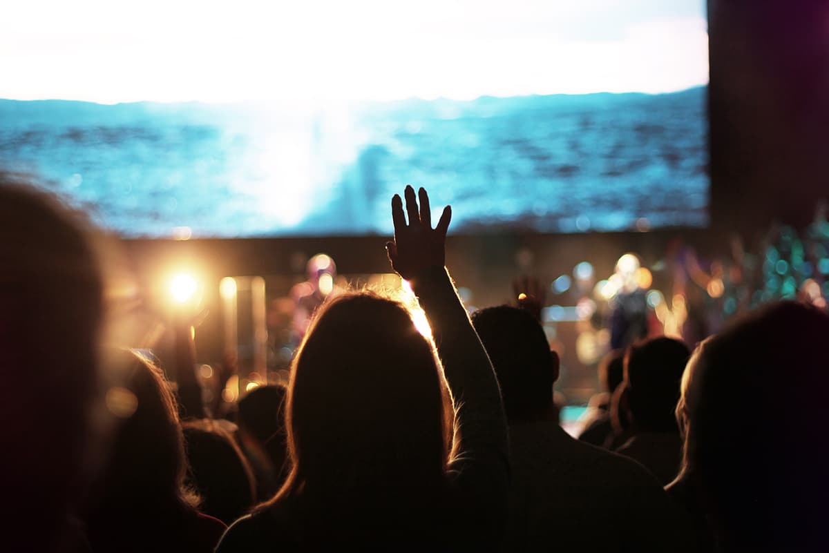 A congregation with hands raised in worship